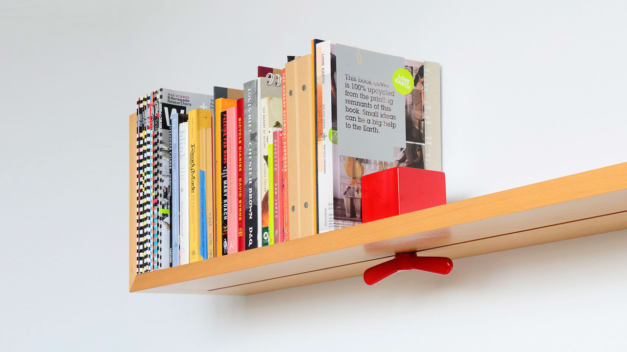 Wall Mounted Shelf Prevents Toppling Books With Sliding Lock