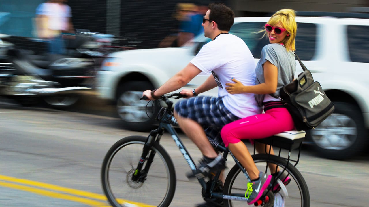 two people on a bicycle