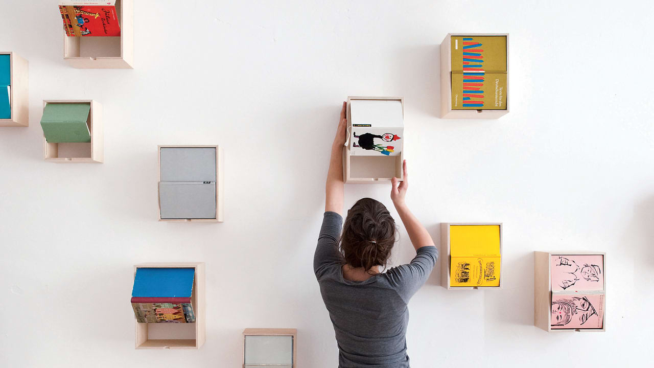 Turn Beautiful Book Covers Into Wall Art That Doubles As Storage