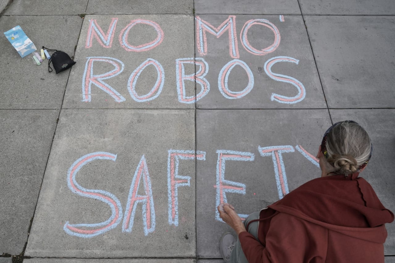 crowd torches waymo self driving car in san francisco