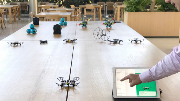 A Parrot drone and iPad Pro in foreground, with other Swift Playgrounds-compatible gadgets behind them.