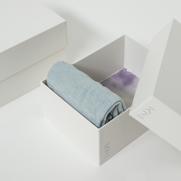 Premium Photo  Happy girl neatly roll folded underwear and socks in  plastic container box marie kondo method