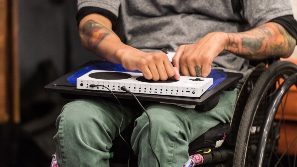 A photograph of someone using the xbox adaptive controller