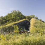 A Futuristic House That Seems To Rise From The Earth